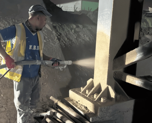 Close-up of high-quality cementitious fireproofing application on a steel beam